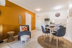 a kitchen and dining room with a table and chairs at Lagoons Resort Apartment 63 in Agnes Water