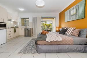 a living room with a couch and a kitchen at Lagoons Resort Studio 64 in Agnes Water