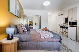 a bedroom with a bed and a kitchen at Lagoons Resort Studio 64 in Agnes Water