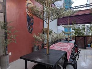 a black table with a tree on top of it at Tzone's Hostel - Quiet Place in Ho Chi Minh City