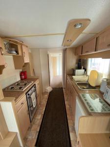 a small kitchen with a stove and a sink at Ingoldmells holiday in Ingoldmells