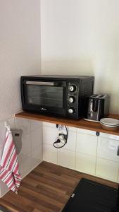 a microwave sitting on top of a counter at AZURÉA Marina ! in Gourbeyre +12 photos