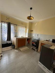 a kitchen with a stove and a counter top at The Mimaced Homes in Homa Bay