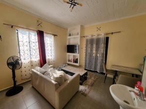 a living room with a couch and a table at The Mimaced Homes in Homa Bay