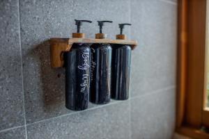 a group of black tubes on a wall at Indigo Blue Ceningan in Nusa Lembongan