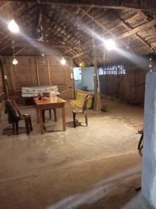 a room with a wooden table and two chairs at Ceylon Bay in Arugam Bay