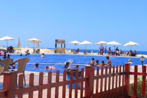 a group of people in a swimming pool at قرية بلوباى مرسي مطروح in Marsa Matruh