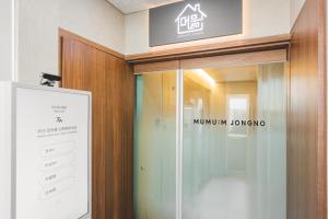 a glass door with a sign in a building at Mumum Jongno in Seoul