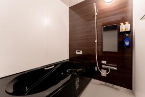 a bathroom with a black sink and a mirror at OZ nikko in Nikko +80 photos