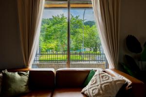 a couch in a living room with a large window at OZ nikko in Nikko