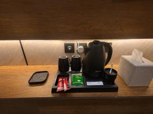 a coffee maker on a tray on a table at Toot Suites Studio in Abha +4 photos