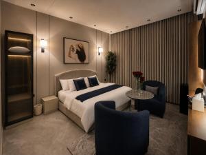 a hotel room with a bed and a table and chairs at Toot Suites Studio in Abha