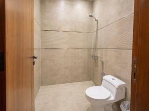 a bathroom with a toilet and a shower at Toot Suites Studio in Abha