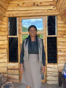 a woman standing in front of a cabin at Eschato tented camp in Gilgil +5 photos