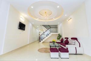 a living room with a couch and a chandelier at House Nguyễn in Da Lat