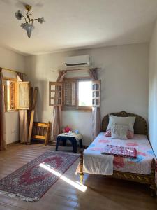 a bedroom with a bed and a window and a table at El Rabwa Rooms in Alexandria