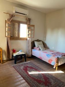 a bedroom with a bed and a table and a window at El Rabwa Rooms in Alexandria