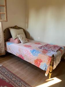 a bedroom with a bed with a colorful blanket at El Rabwa Rooms in Alexandria
