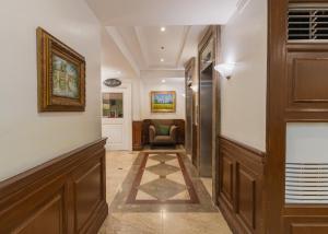 a hallway with a waiting room with a chair at Orchid Garden Suites in Manila