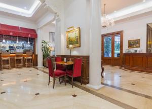 a dining room with a table and chairs and a bar at Orchid Garden Suites in Manila