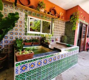a bathroom with a sink with tiles on the wall at Casa Punta Perula VILLAS in Pérula