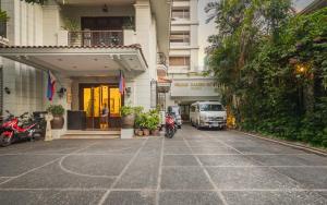 a car is parked in front of a building at Orchid Garden Suites in Manila