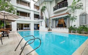 a large swimming pool in the middle of a building at Orchid Garden Suites in Manila