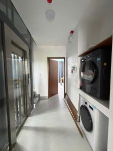 a living room with a microwave and a hallway at BEER HOMESTAY Huế - FREE POOL & GYM in Hue +8 photos