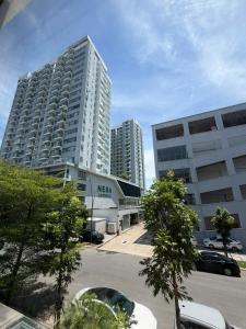 two tall buildings in a city with a parking lot at BEER HOMESTAY Huế - FREE POOL & GYM in Hue