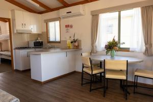 a kitchen and living room with a table and chairs at Beaufort Lake Caravan Park in Beaufort