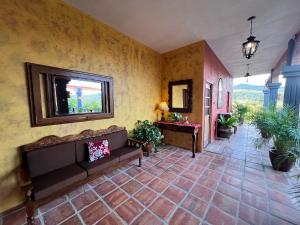 a living room with a couch and a table at Casa Punta Perula VILLAS in Pérula