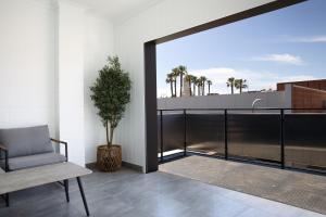 a chair and a potted plant on a balcony at The Lime Loft, Rooftop Views in Mildura's CBD in Mildura