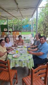 a group of people sitting around a table at Hospedaje restaurant Sr de Sipan in Sipán +9 photos