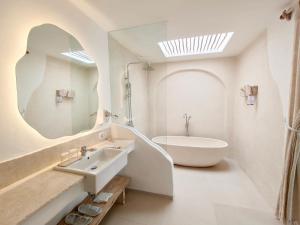 a white bathroom with a sink and a mirror at Villa Nala Uluwatu by LODGELINK BALI in Uluwatu +33 photos