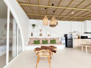 a living room with a table and a kitchen at Villa Nala Uluwatu by LODGELINK BALI in Uluwatu