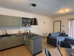 a kitchen and a living room with a couch at Serendipity in Elmas