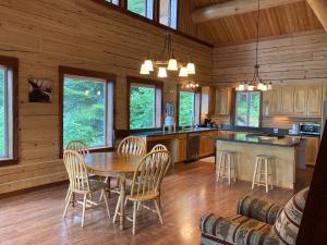 a kitchen with a table and chairs in a cabin at Beach Roadhouse in Haines