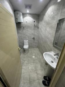 a bathroom with a toilet and a sink at شقة غرفة وصالة in Musaylah