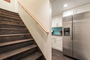 a kitchen with a staircase and a refrigerator at Executive Stay Inn free parking in Oakland