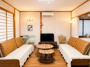 a living room with two couches and a table at 春まち in Ito