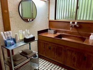 a bathroom with a sink and a mirror at 春まち in Ito +25 photos