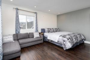 a bedroom with a bed and a couch and a window at Executive Stay Inn free parking in Oakland