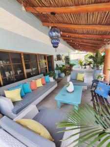 an outdoor patio with couches and a table at Casa Punta Perula Boutique Hotel in Pérula