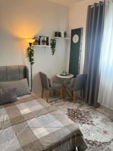 a bedroom with a bed and a table and chairs at Santai at KotaWarisan KLIA Netflix in Sepang +10 photos