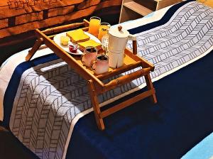 a tray of food on a table on a bed at Hotel Golden La Paz in Callampaya