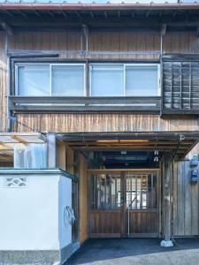 an entrance to a building with a wooden door at 一棟貸しホテル Shirahama WAKO in Shirahama
