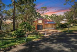 a house with a garage and a driveway at Sunset Nest No 1 in Sanctuary Point
