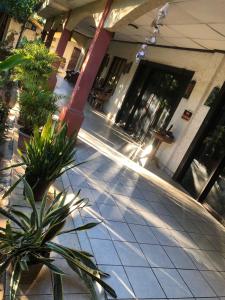 a building with potted plants on a sidewalk at Hotel La Estacion in La Unión
