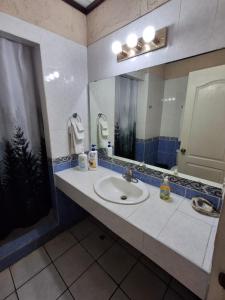 a bathroom with a sink and a mirror at Hotel La Estacion in La Unión