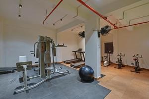 a gym with several exercise equipment in a room at Hotel Camel managed by CLAY in Mundra